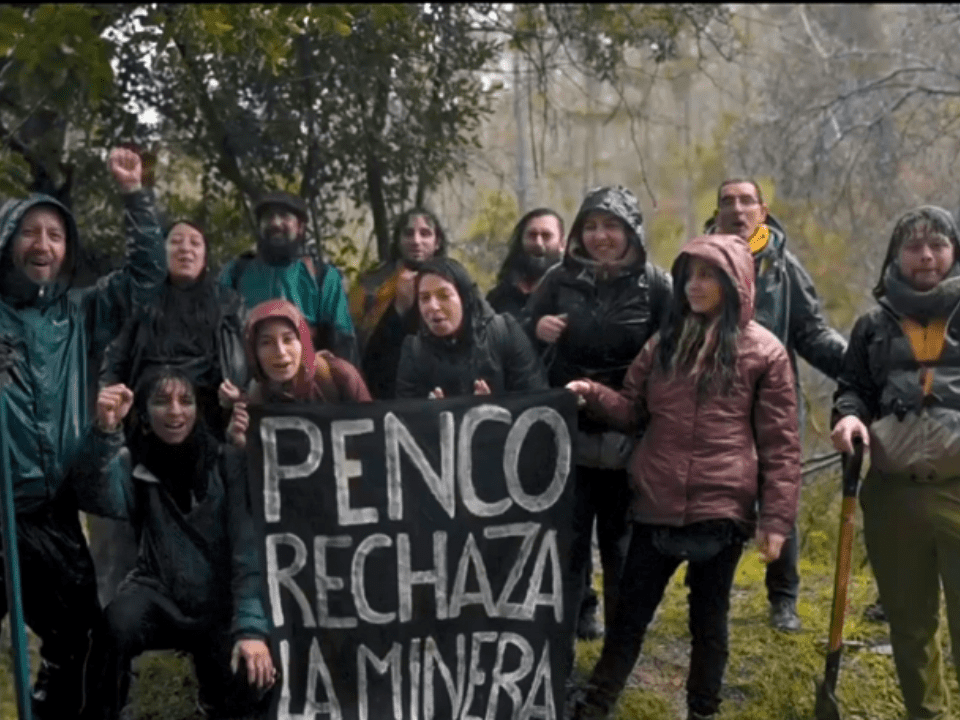 Protestors in Chile holding a sign that says "Penco Rechaza La Minera"