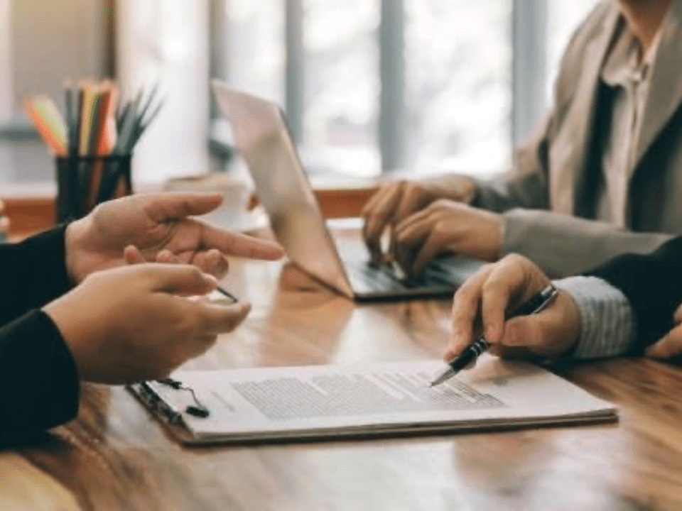 People around a table reviewing documents